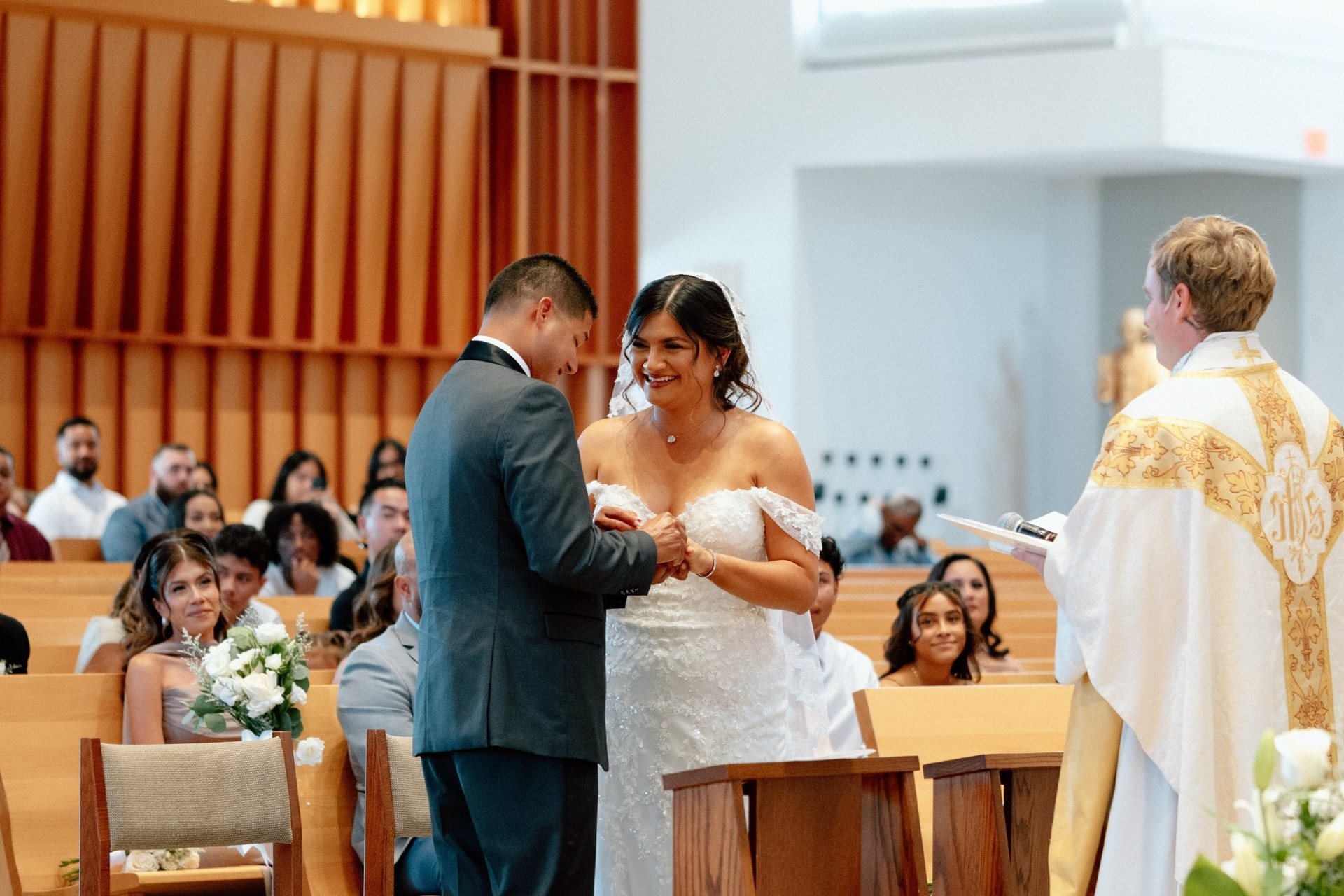 Bride smiling at the groom during their church ceremony.