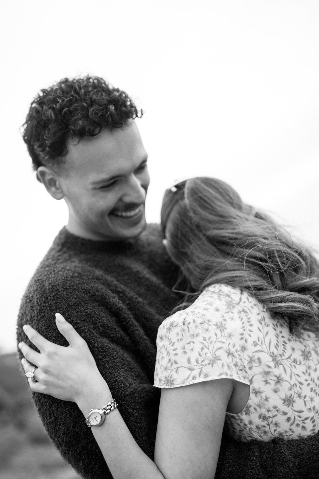 Black-and-white portrait of a couple holding each other.